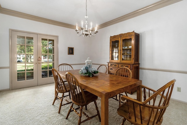 carpeted dining room with french doors, an inviting chandelier, and crown molding