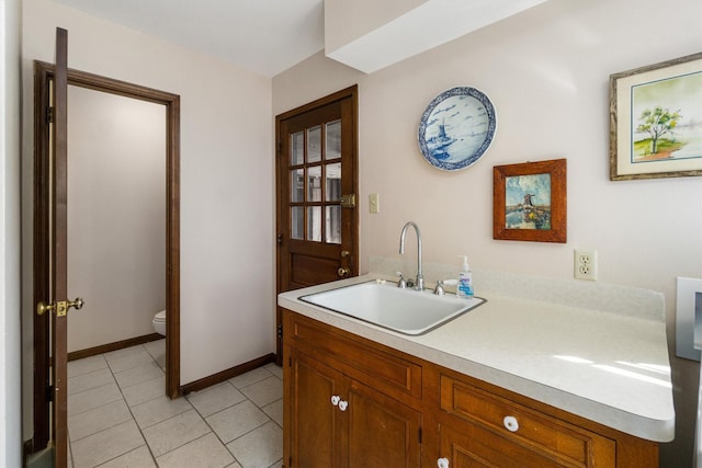 interior space with sink and light tile patterned floors