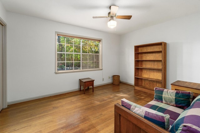 sitting room featuring light hardwood / wood-style floors and ceiling fan