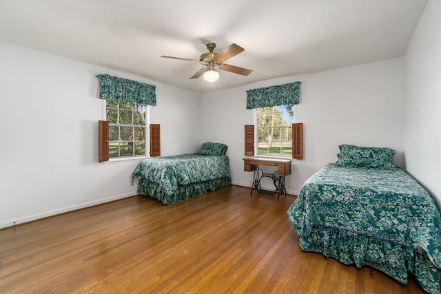 bedroom with ceiling fan and hardwood / wood-style flooring