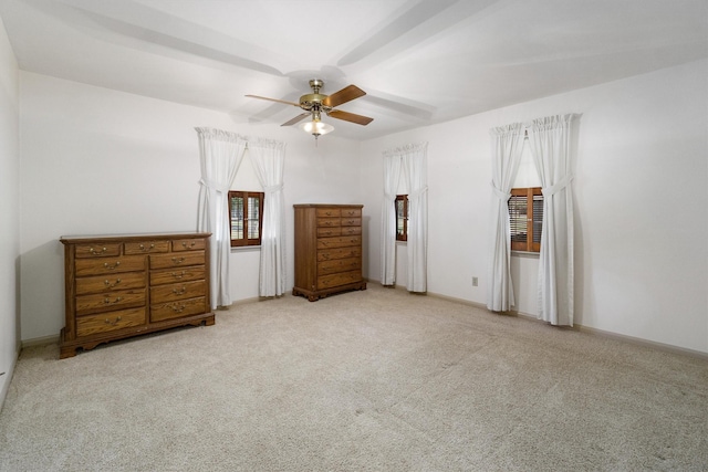 unfurnished bedroom featuring ceiling fan and light colored carpet