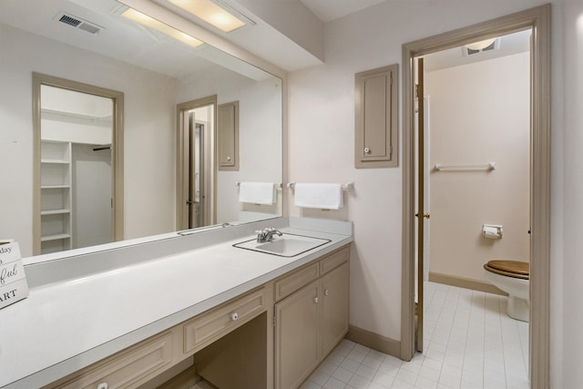 bathroom with tile patterned floors, vanity, and toilet