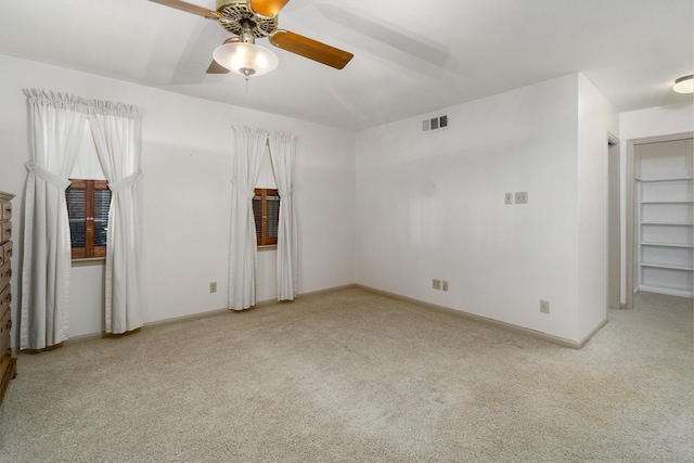 carpeted empty room with ceiling fan