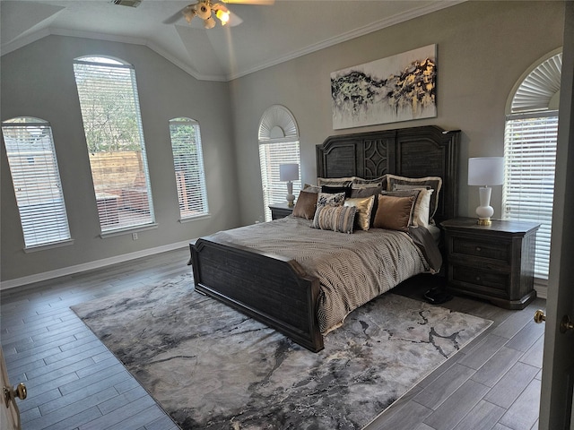 bedroom featuring hardwood / wood-style flooring, ceiling fan, crown molding, and vaulted ceiling