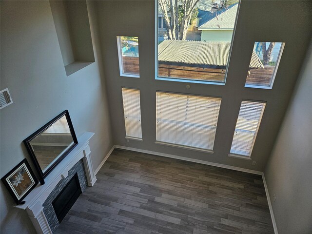 unfurnished living room with dark wood-type flooring