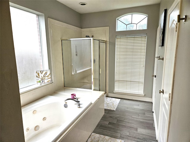 bathroom with hardwood / wood-style flooring and plus walk in shower