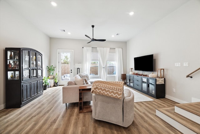 living room featuring ceiling fan and hardwood / wood-style flooring