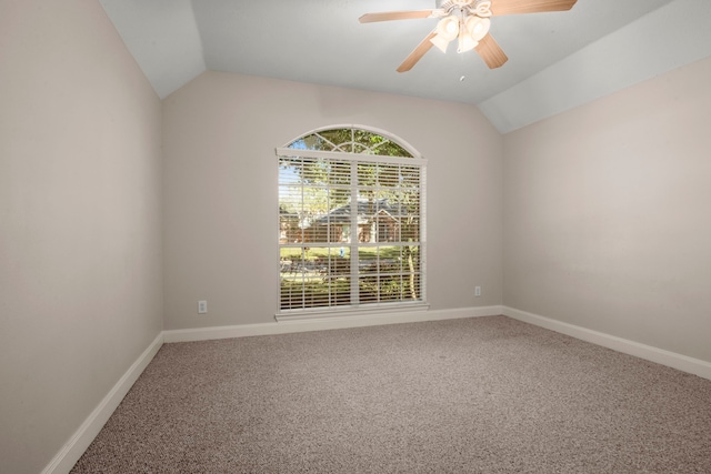 empty room with carpet flooring, ceiling fan, and vaulted ceiling