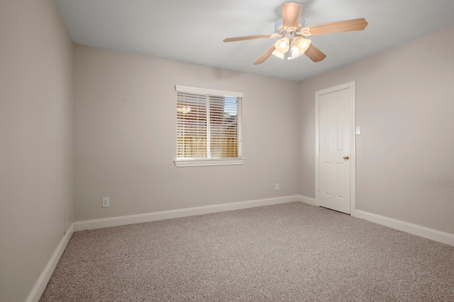 carpeted spare room featuring ceiling fan