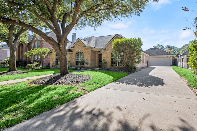 view of front of property featuring a garage and a front lawn