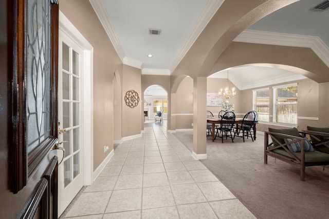 corridor featuring light tile patterned floors, an inviting chandelier, and ornamental molding