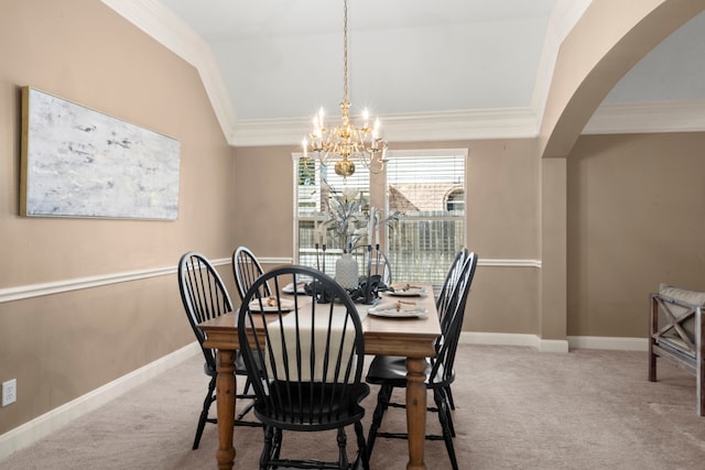 dining room featuring light carpet, ornamental molding, lofted ceiling, and a notable chandelier