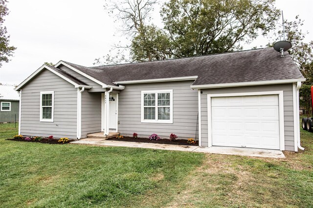 ranch-style home with a front yard and a garage