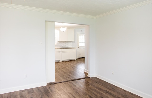 unfurnished room featuring ornamental molding and wood-type flooring