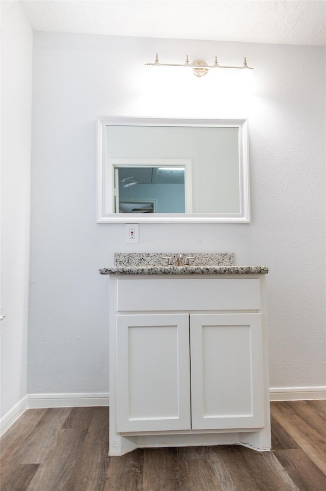 bathroom with hardwood / wood-style floors and vanity