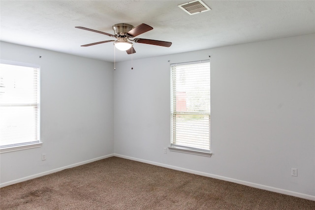 carpeted spare room featuring ceiling fan