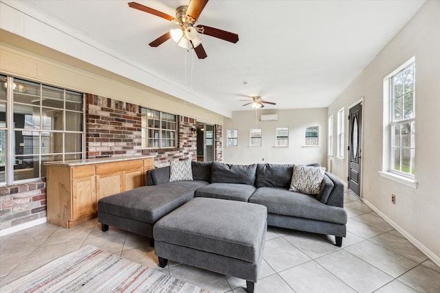 tiled living room featuring a wall mounted air conditioner, ceiling fan, and brick wall