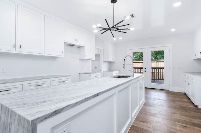 kitchen featuring dark hardwood / wood-style flooring, white cabinetry, and sink