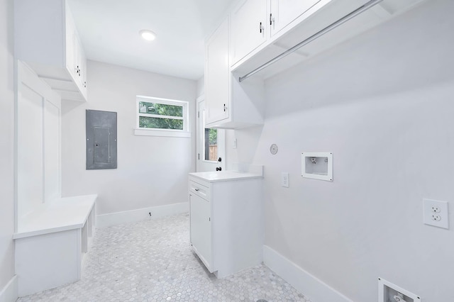 washroom featuring cabinets, washer hookup, and electric panel