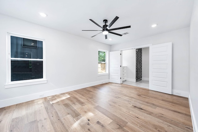 unfurnished bedroom with light hardwood / wood-style floors and ceiling fan