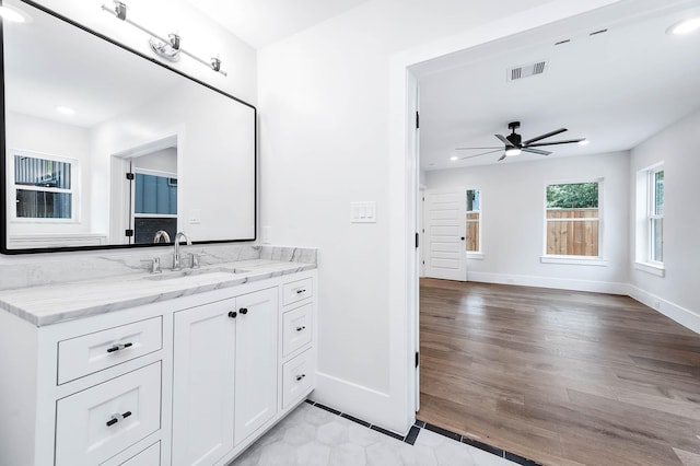 bathroom featuring ceiling fan, hardwood / wood-style floors, and vanity