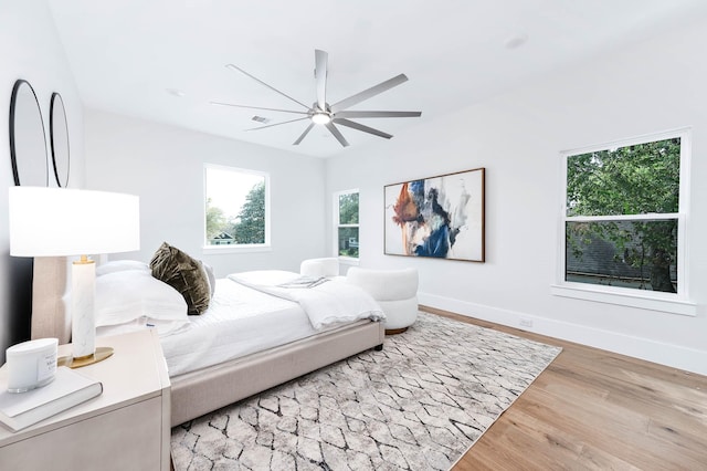 bedroom with hardwood / wood-style flooring and ceiling fan