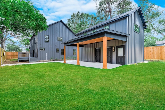 back of property featuring a patio and a lawn