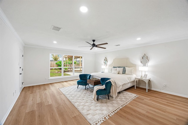 bedroom featuring ceiling fan, light hardwood / wood-style floors, and ornamental molding