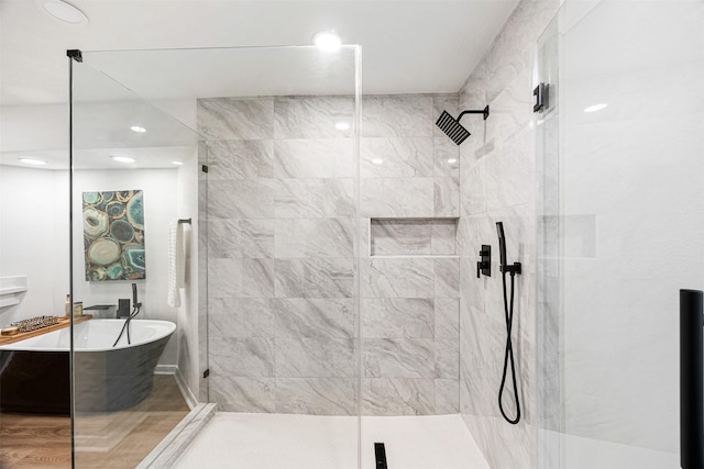 bathroom featuring shower with separate bathtub