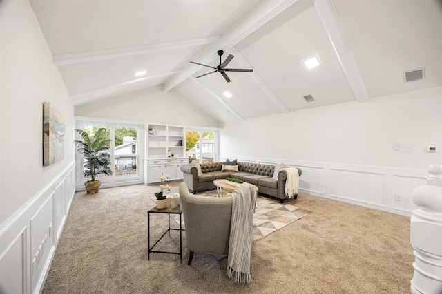 living room with vaulted ceiling with beams, light colored carpet, and ceiling fan