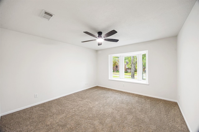 carpeted empty room featuring a textured ceiling and ceiling fan