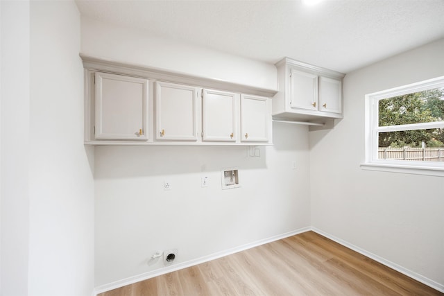 laundry area featuring gas dryer hookup, cabinets, washer hookup, hookup for an electric dryer, and light hardwood / wood-style floors