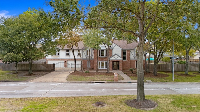 view of front of property with a garage and a front lawn