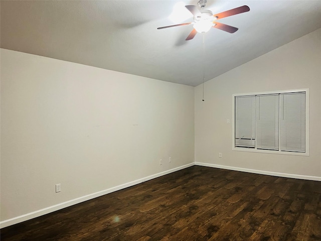 empty room featuring lofted ceiling, ceiling fan, and dark wood-type flooring