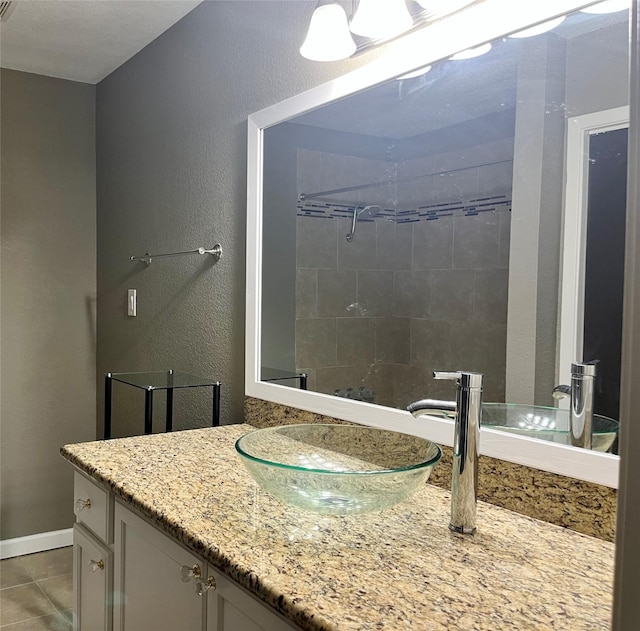 bathroom with tile patterned flooring and vanity