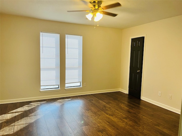 empty room with dark hardwood / wood-style floors and ceiling fan