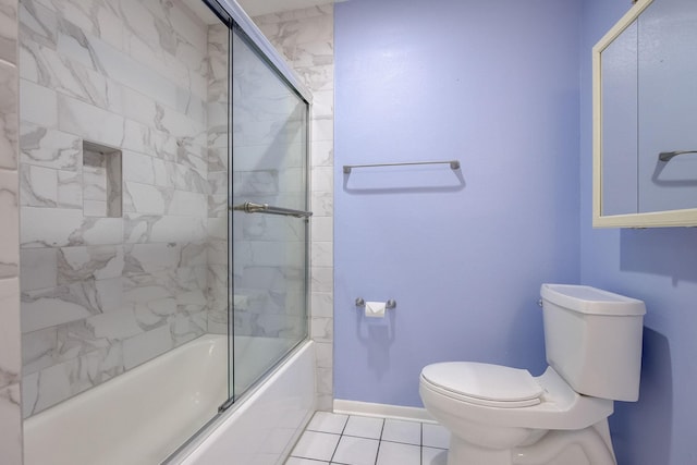 bathroom with tile patterned flooring, toilet, and enclosed tub / shower combo