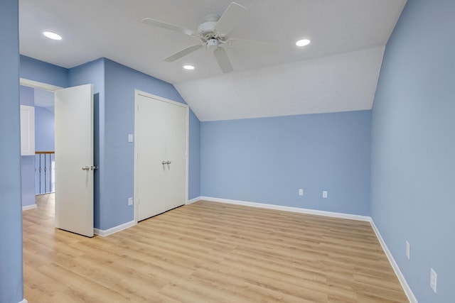 bonus room with light wood-type flooring, vaulted ceiling, and ceiling fan