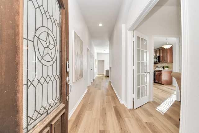 hall with light hardwood / wood-style flooring