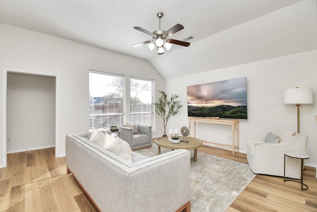 living room with hardwood / wood-style floors, vaulted ceiling, and ceiling fan