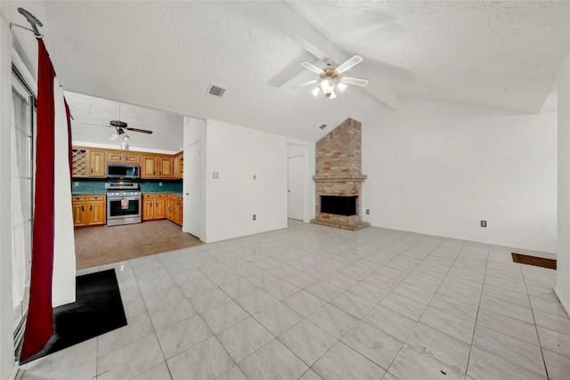 unfurnished living room with a brick fireplace, vaulted ceiling with beams, ceiling fan, light tile patterned floors, and a textured ceiling