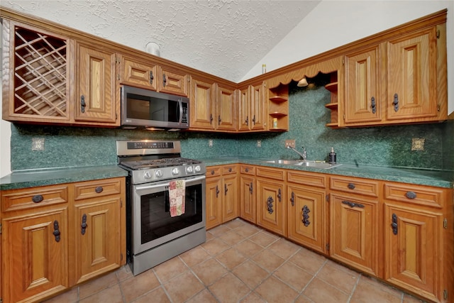 11907 E Marsham Cir, Houston, TX 77066 - kitchen featuring appliances with stainless steel finishes, lofted ceiling, light tile patterned floors, backsplash, and open shelves
