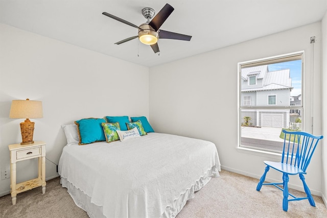 bedroom with ceiling fan and light carpet