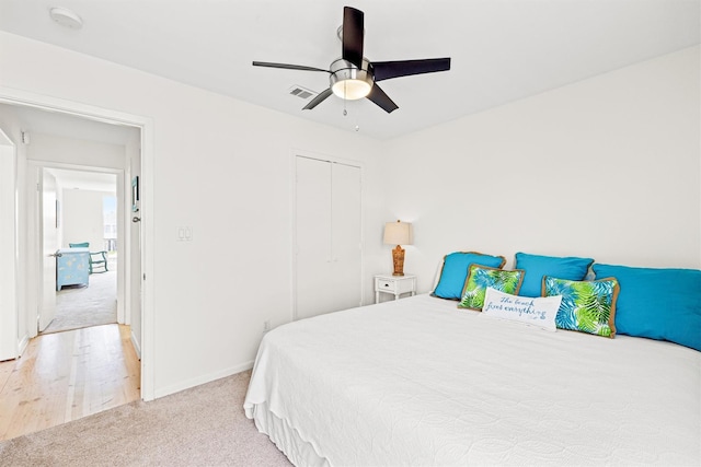 carpeted bedroom with a closet and ceiling fan