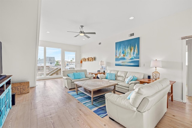 living room featuring light wood-type flooring and ceiling fan