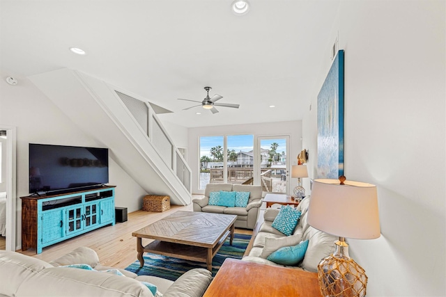 living room featuring ceiling fan and light hardwood / wood-style flooring