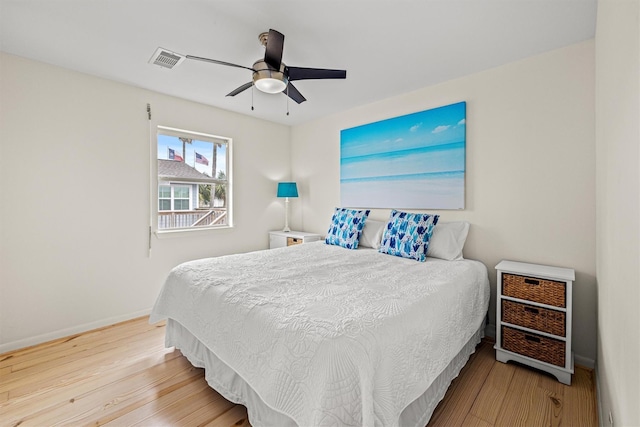 bedroom with ceiling fan and hardwood / wood-style flooring