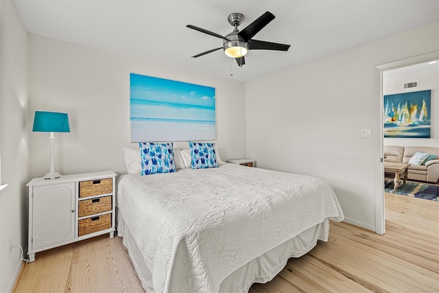 bedroom with ceiling fan and light hardwood / wood-style flooring