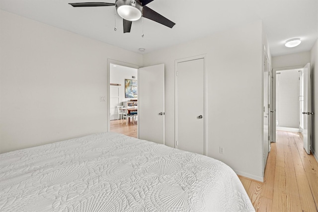 bedroom featuring light wood-type flooring and ceiling fan