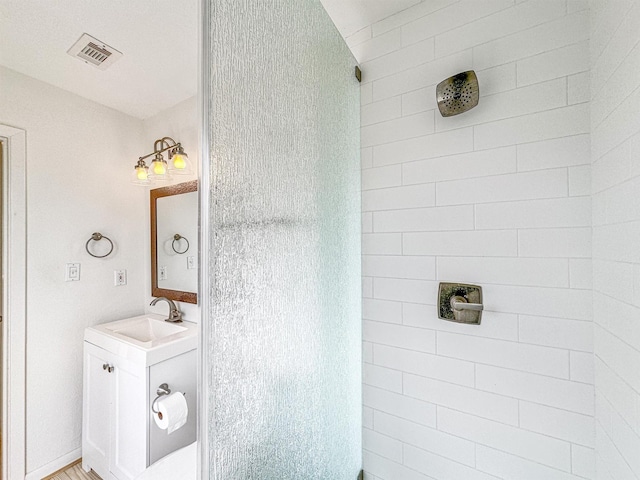 bathroom with vanity and a shower